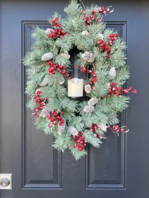 Oval Flocked Winter Pine Wreath with Flickering Candle